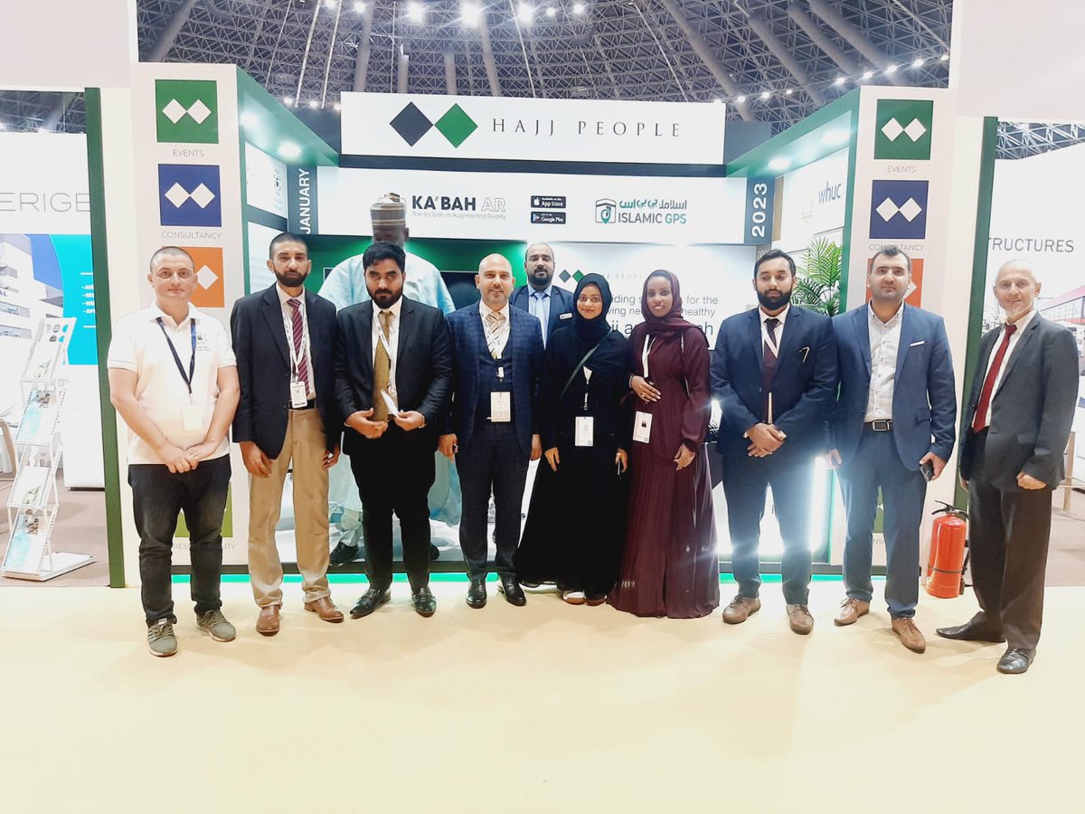 The Hajj People team standing in front of their exhibition stand